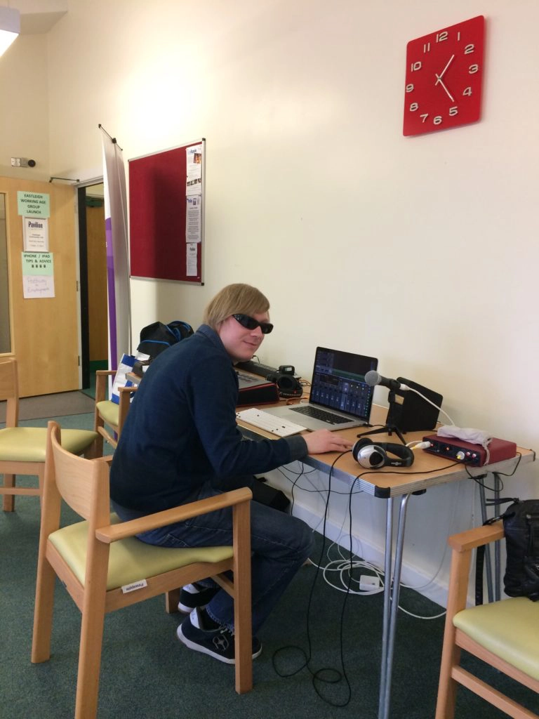Included is a picture of David sitting at a table with the laptop in front of him, a microphone plugged into the Sound Card on his right, and the MIDI keyboard on his left.