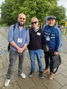 They are standing outside the Pavilion on the Park in Eastleigh, with trees behind them.